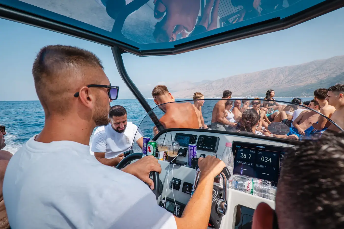 The Beast Boat captain at the wheel with the throttles and instrument display in front of him